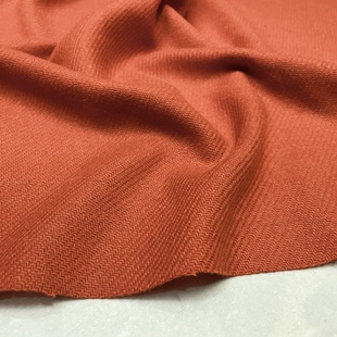 橘色细人字斜纹毛呢布料，春秋保暖纯色裙子，外套设计师服装面料
