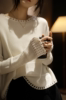 羊毛衫女薄款高级感白色，优雅圆领宽松套头，镂空针织打底衫短款毛衣