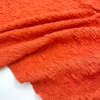 柔软亲肤  棉质橘红色凹凸肌理褶皱弹力布料春夏上衣连衣裙面料